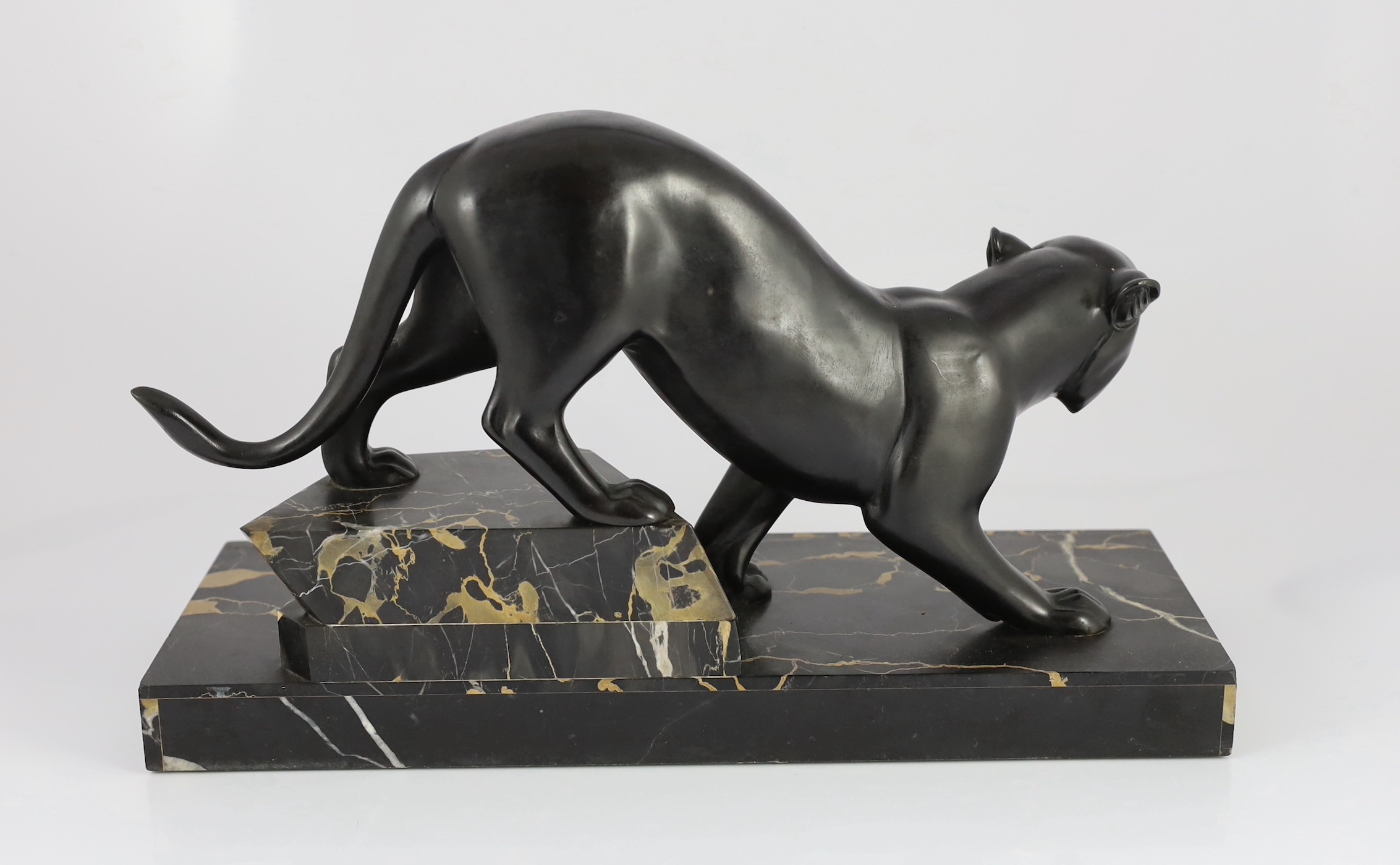 Irene Rochard. A French Art Deco bronzed spelter and marble model of a black panther, 44cm wide, 27cm high